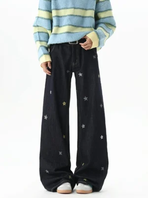 Front view of dark indigo star embroidered wide-leg jeans styled with a striped fuzzy sweater and white sneakers