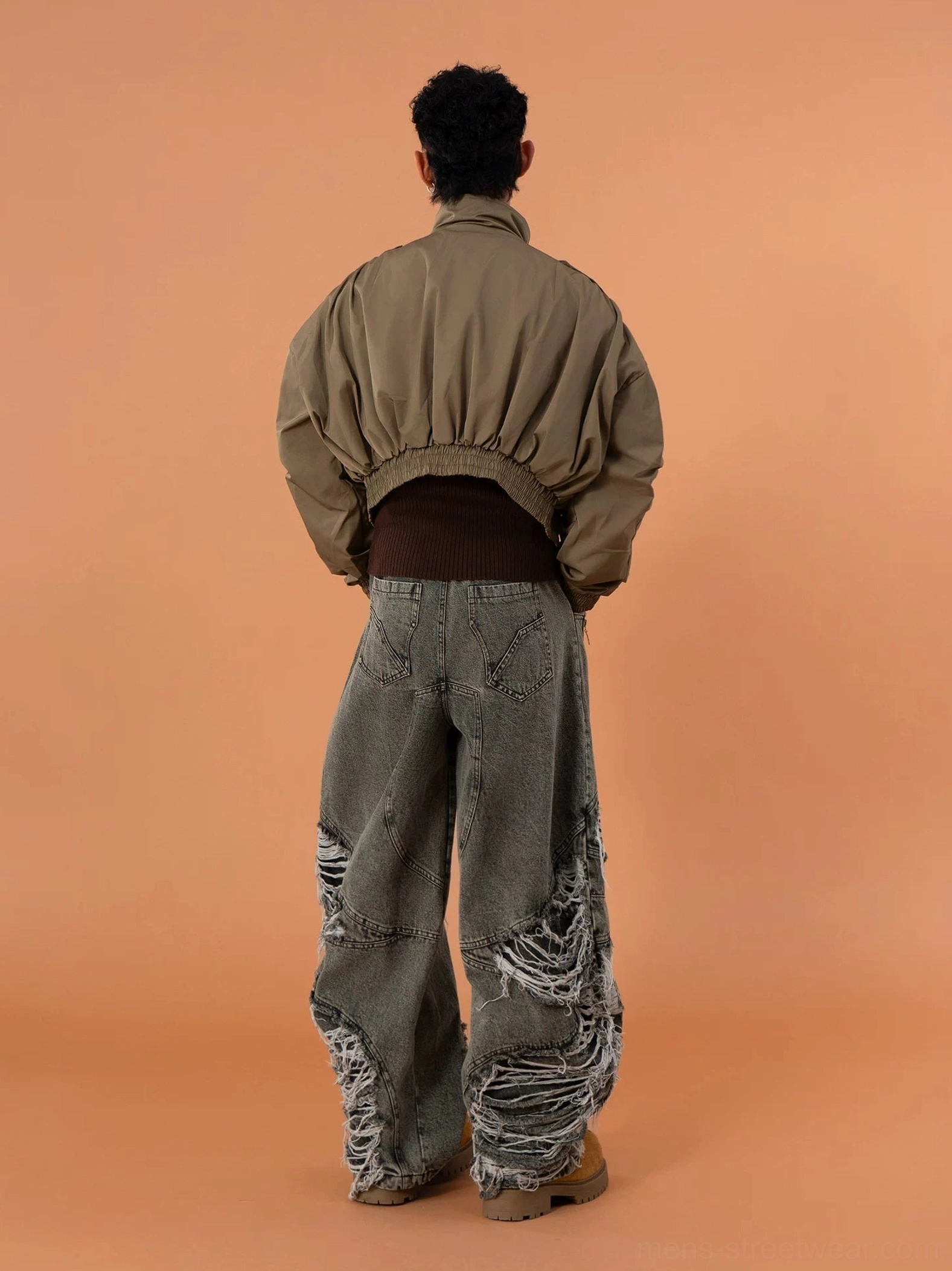 Rear full view of a military green cropped bomber jacket with ruched elasticated back hem loose sleeves and utility-inspired shoulder details