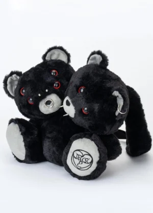 Front flat lay of a black dual evil bear plush backpack with red ring eyes, piercings, gray inner ears, and hidden pocket details