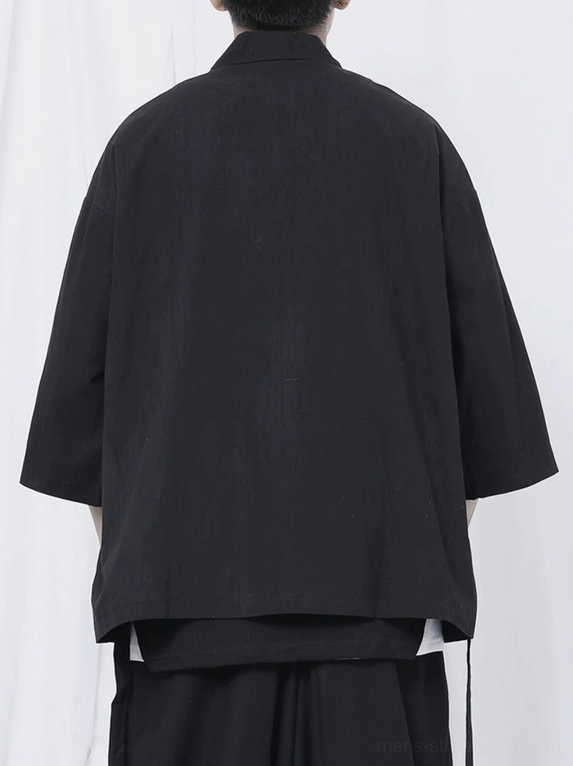 Minimal black wrap kimono shirt designed for unisex streetwear layering and avant-garde monochrome outfits