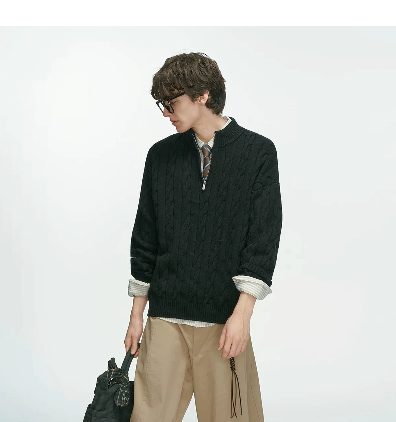 Cable-knit half-zip pullover sweater showing clean minimal construction and oversized contemporary streetwear proportions