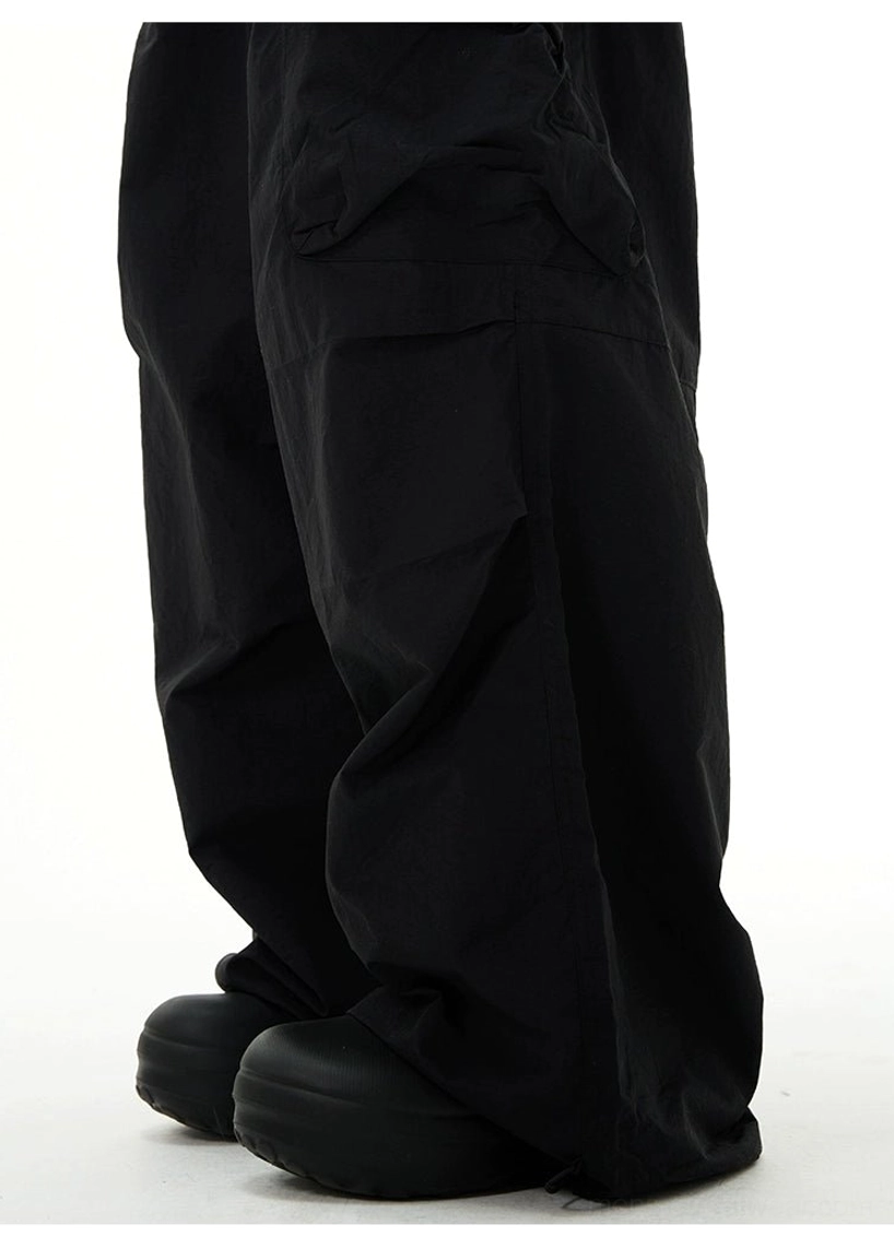 Minimal monochrome black windbreaker and cargo pants outfit with relaxed Seoul streetwear proportions