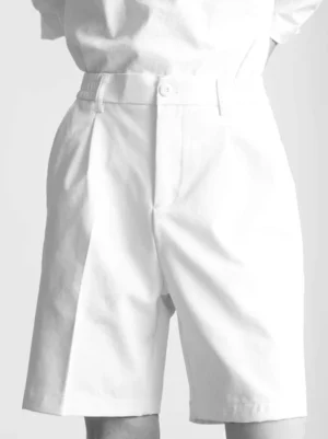 Front close-up of white minimal tailored pleated shorts with high waist, belt loops, single front pleat, straight above-knee cut, and smooth Korean streetwear styling