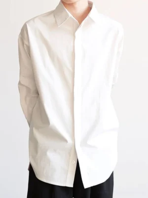 White relaxed fit cotton poplin shirt showing clean concealed placket and oversized streetwear silhouette