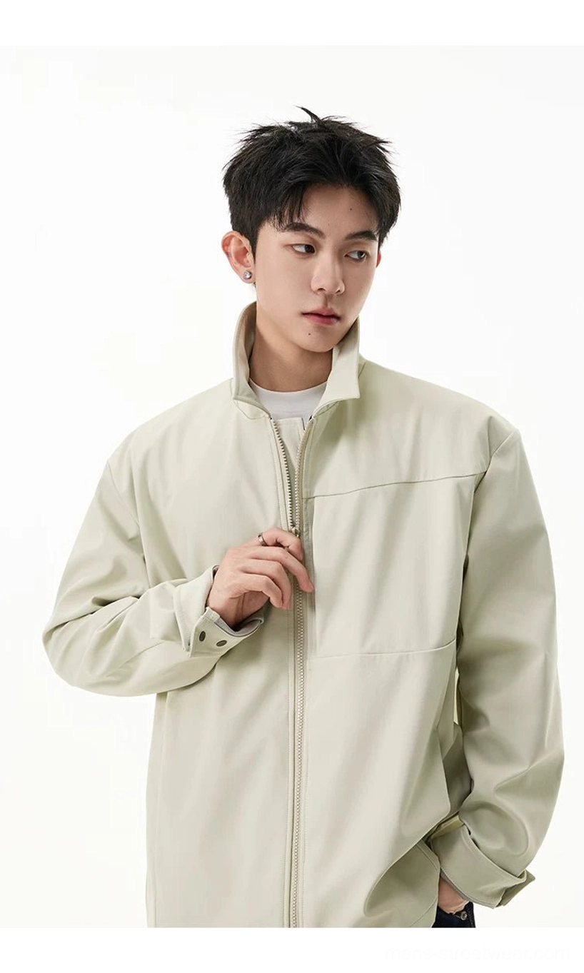Close-up view of men's pale beige zip shirt jacket with adjustable cuffs and relaxed sleeves