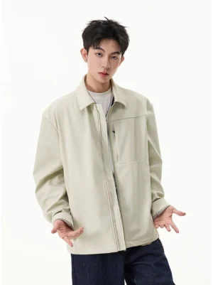 Men's pale beige zip shirt jacket with relaxed silhouette worn over a white tee and dark jeans