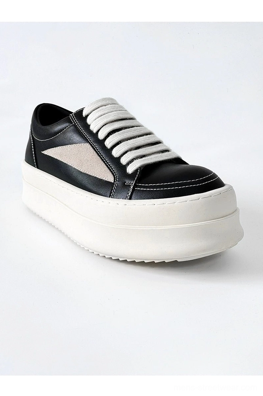 Minimalist black platform sneakers with lace-up closure and contemporary urban fashion styling