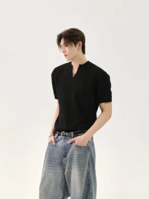 Black minimalist V-neck knit T-shirt for men shown in left three-quarter view on male model