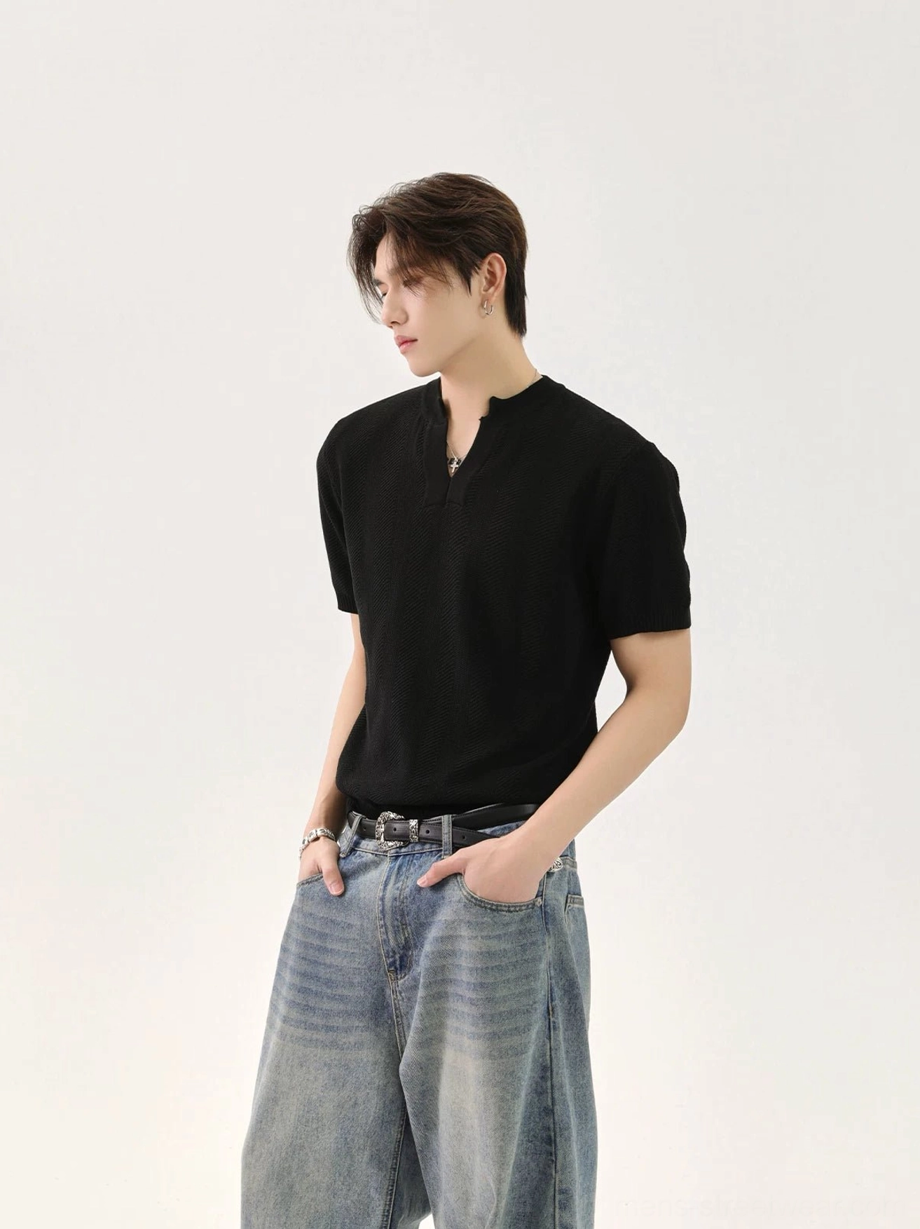 Black minimalist V-neck knit T-shirt for men shown in left three-quarter view on male model