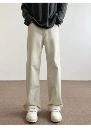 Off white minimalist cotton straight leg pants front view styled with black sweatshirt and white sneakers