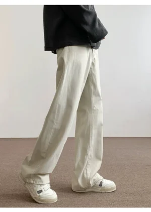 Off white relaxed straight leg cotton pants side view with full length sneaker drape