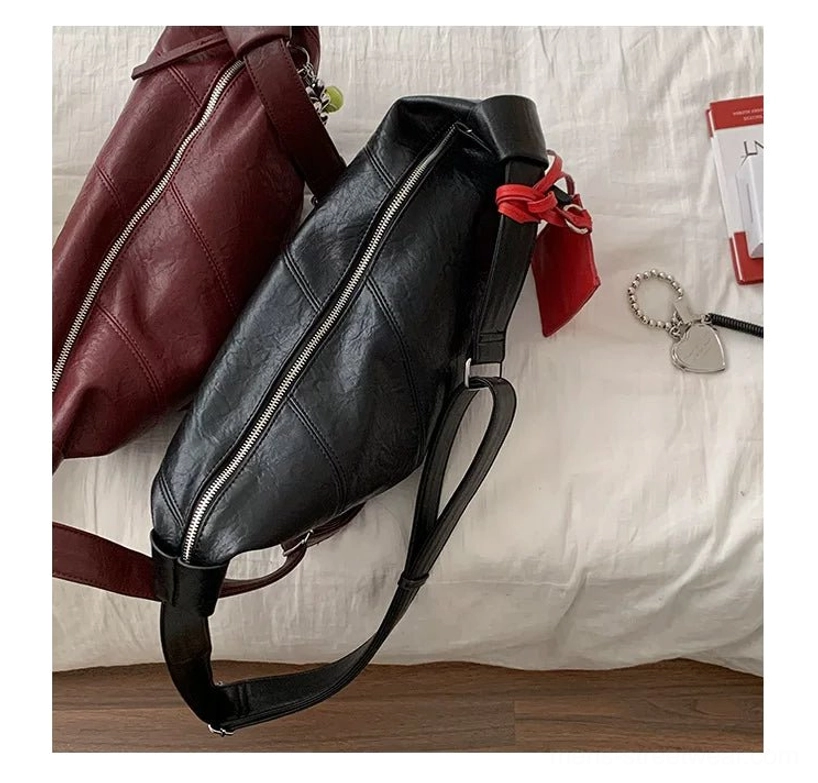Black and coffee brown curved PU leather crossbody sling bags displayed flat with zipper closures