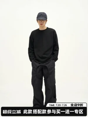 Black relaxed fit cotton long sleeve crew neck t-shirt styled with black cargo pants for minimalist streetwear