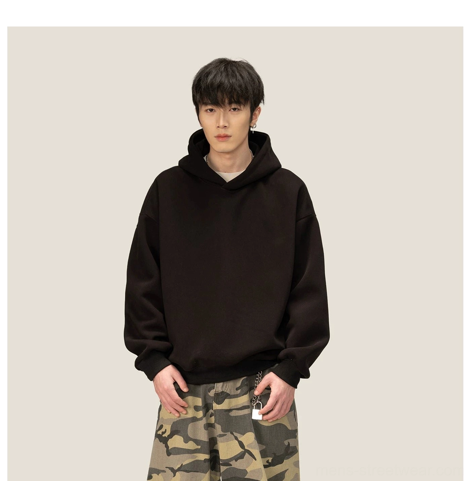 Full front view of minimalist oversized black fleece hoodie with standard hood and ribbed hem
