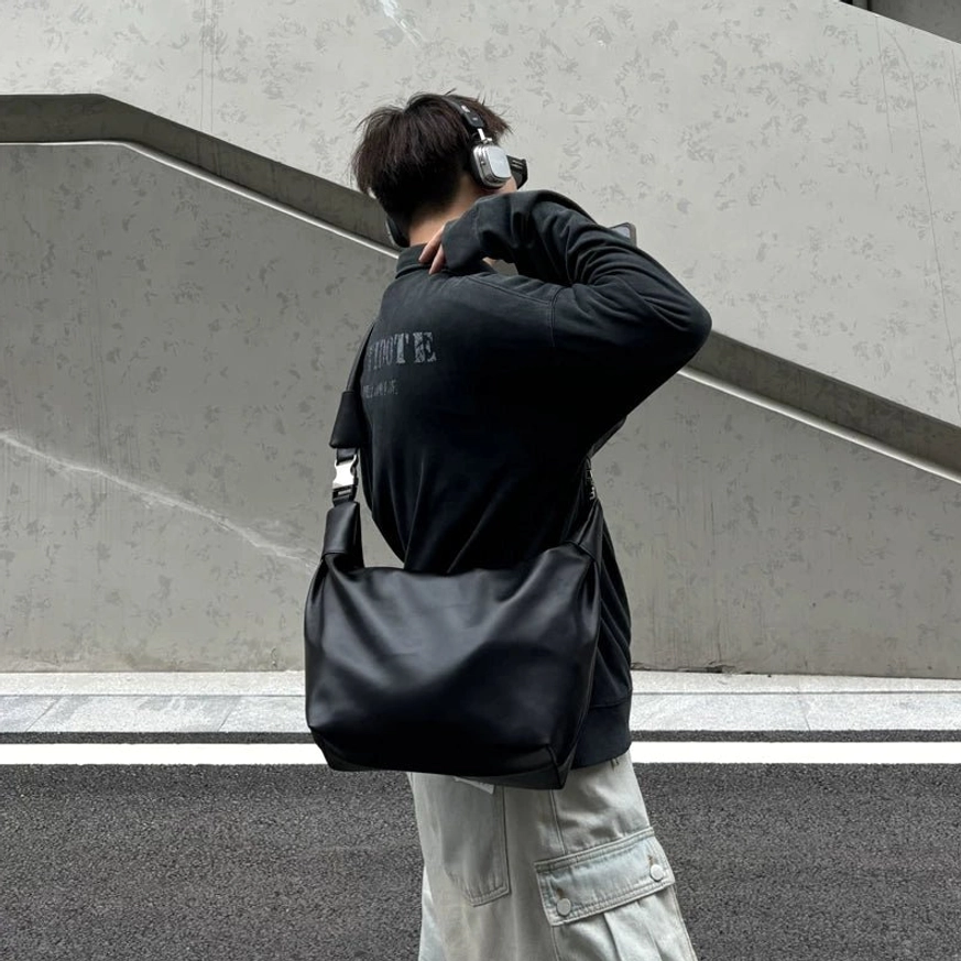 Black minimalist PU leather streetwear crossbody shoulder sling bag with large zippered daily carry compartment