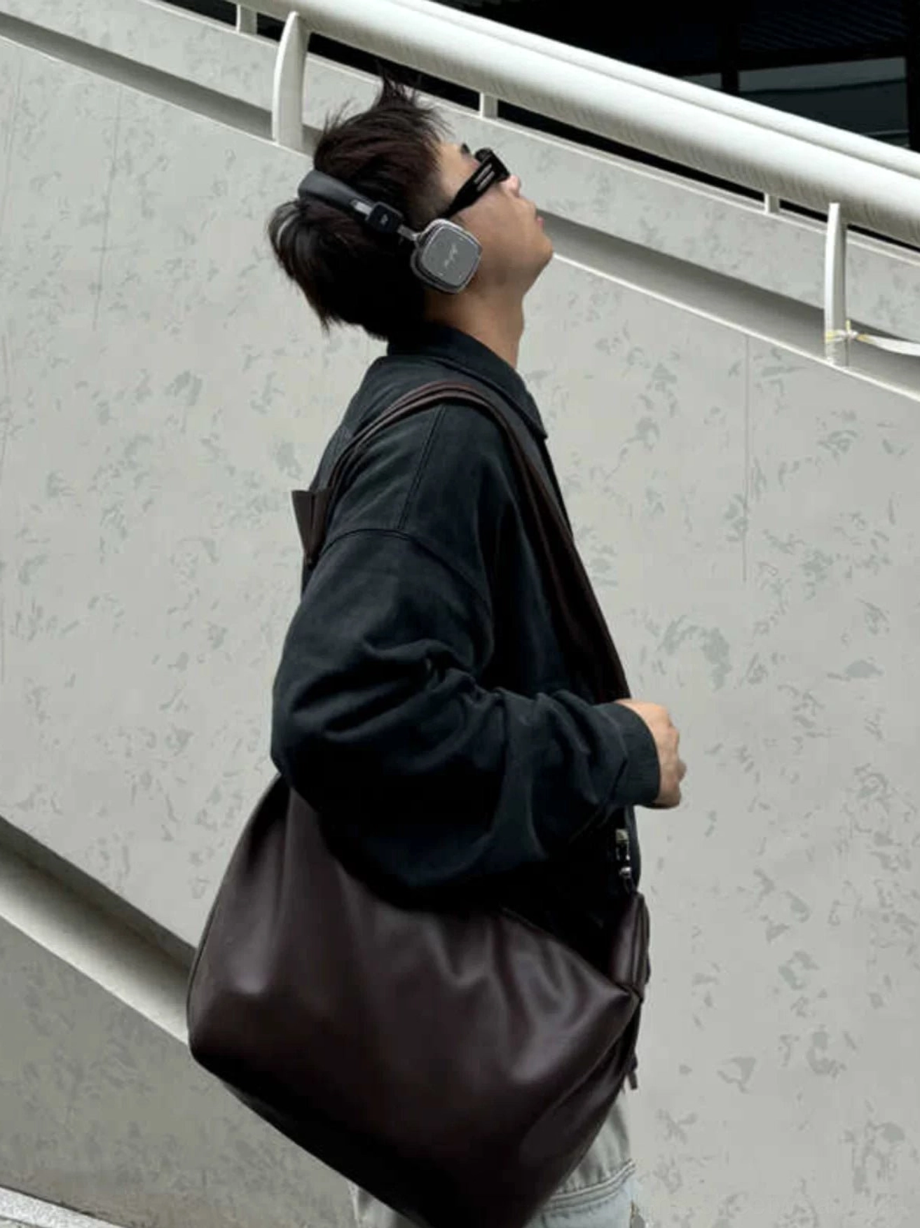 Brown PU leather crossbody sling bag worn on the back in a Seoul-inspired streetwear outfit