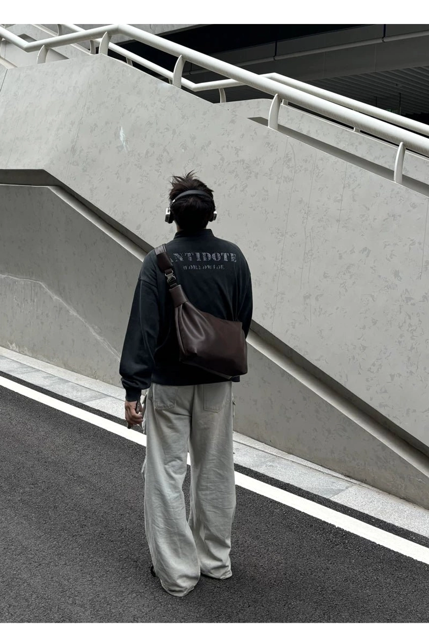 Dark brown streetwear shoulder sling bag direct rear view showing wide strap and crossbody fit