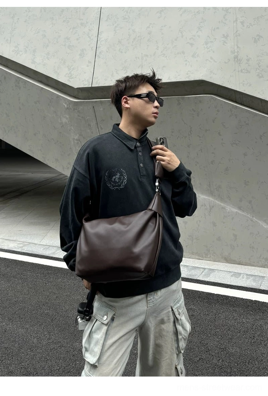 Brown minimalist PU leather crossbody sling bag front view showing rounded curved pouch shape and smooth surface