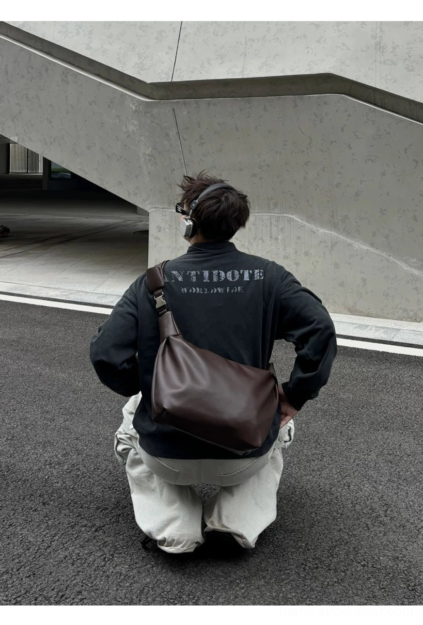 Brown streetwear crossbody shoulder sling bag fitted close to the hip in rear overhead wearing view