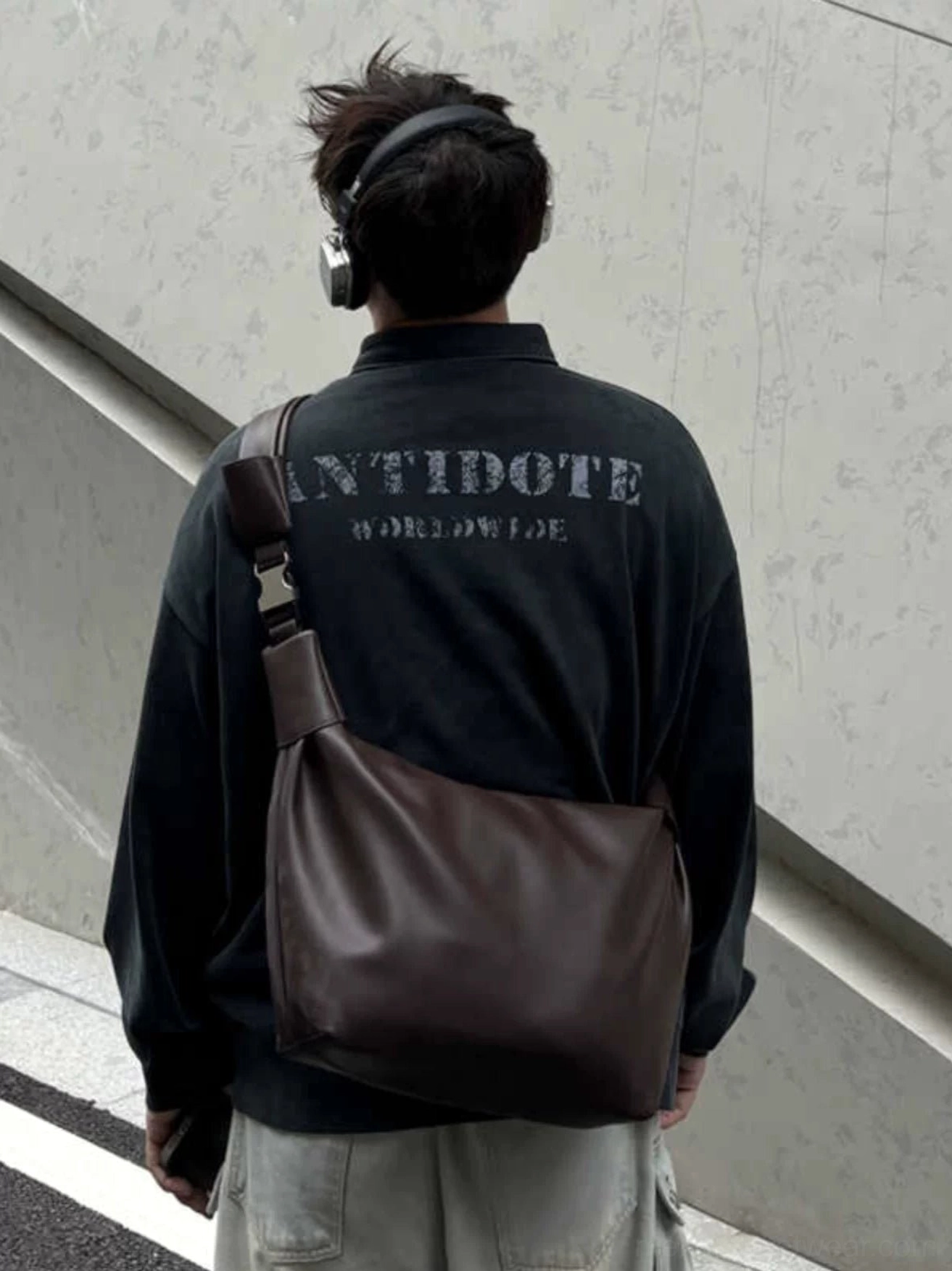 Dark brown minimalist PU leather streetwear crossbody shoulder sling bag worn across the back with cargo pants