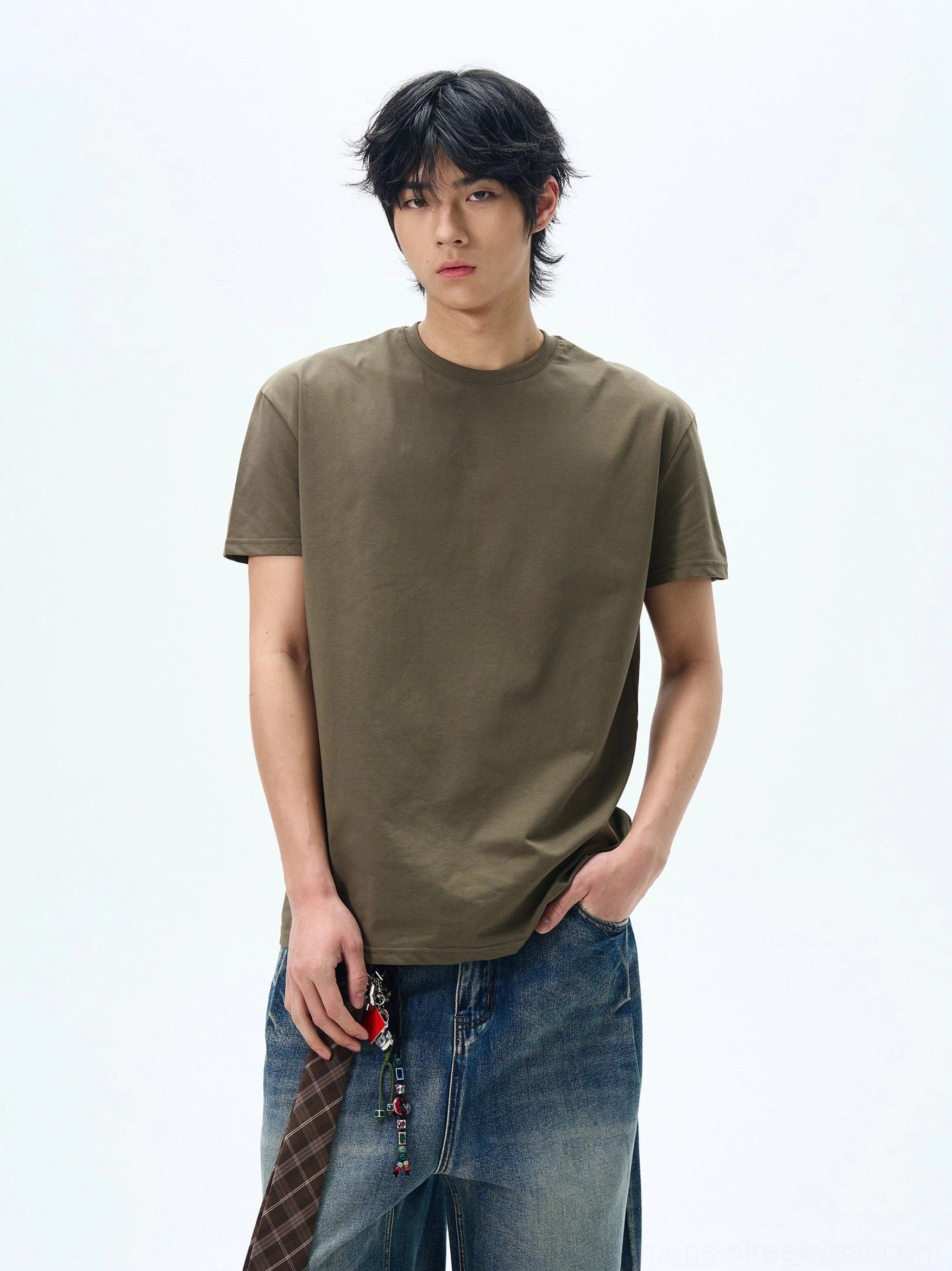 Army green minimalist relaxed crew neck t-shirt shown on a male model in a clean studio setting