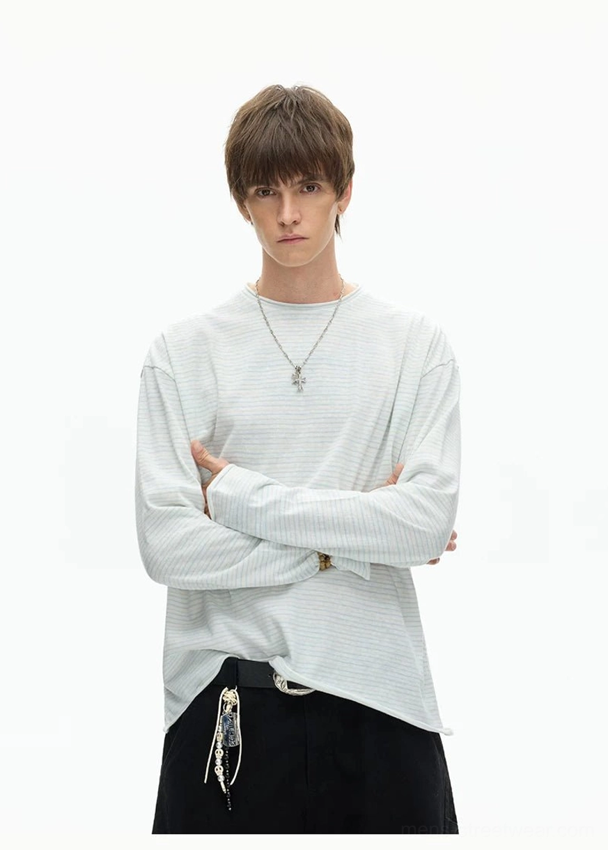 Close-up front view of a minimalist solid grey crew neck long sleeve tee with relaxed fit and clean neckline
