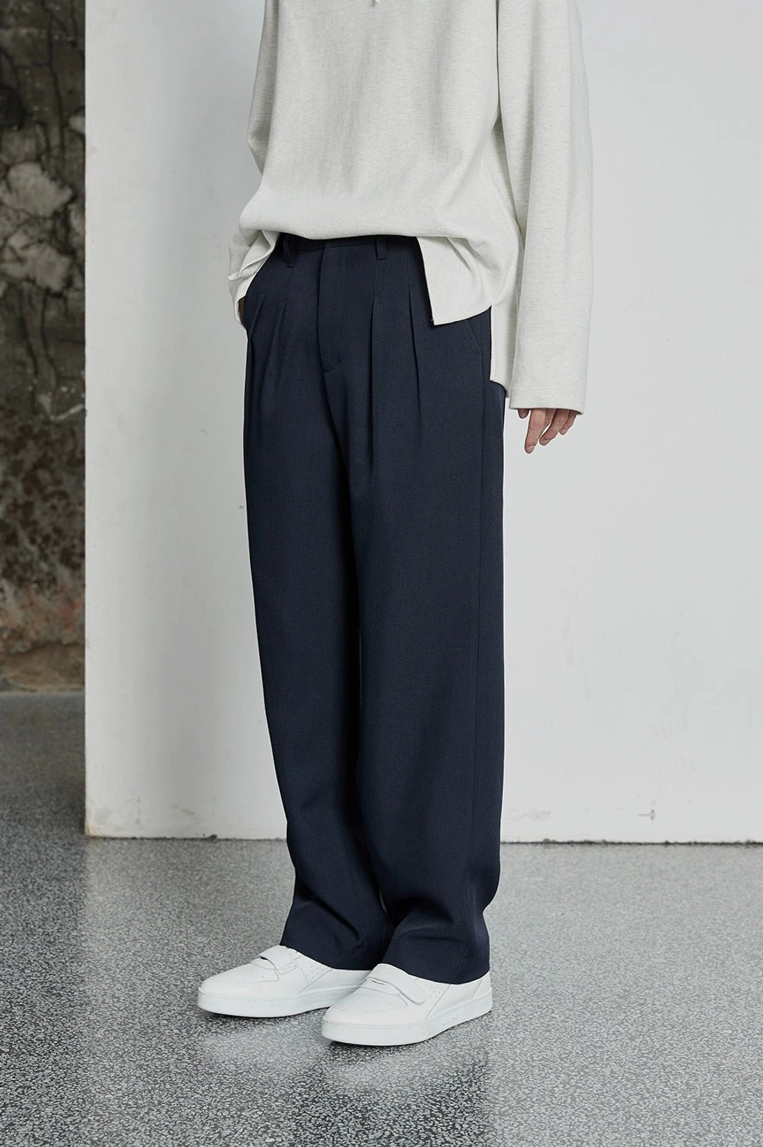 Minimalist streetwear dress pants with structured front pleats and adjustable leg opening