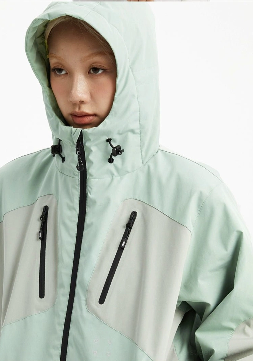 Close-up of mint green color-block jacket hood and chest with adjustable drawstrings and zippered pockets