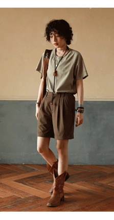 Mint green cotton raglan sleeve T-shirt styled with brown tailored shorts and ankle cowboy boots