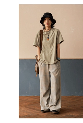 Mint green relaxed raglan crew neck T-shirt paired with light gray wide-leg pants and bucket hat