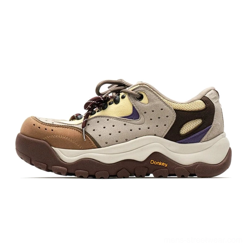 Two-tone mixed color chunky trail sneakers with suede-like panels, purple accents, thick cushioned midsole, and technical streetwear styling