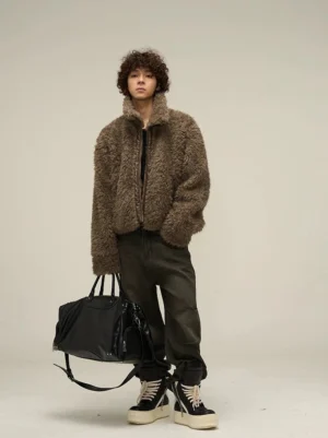 Mocha brown faux shearling cropped jacket in a left three-quarter full-body streetwear outfit with cargo jeans and platform sneakers