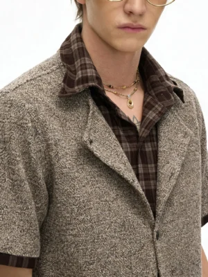 Close-up of mocha plaid layered knit shirt with textured melange knit body and contrast collar