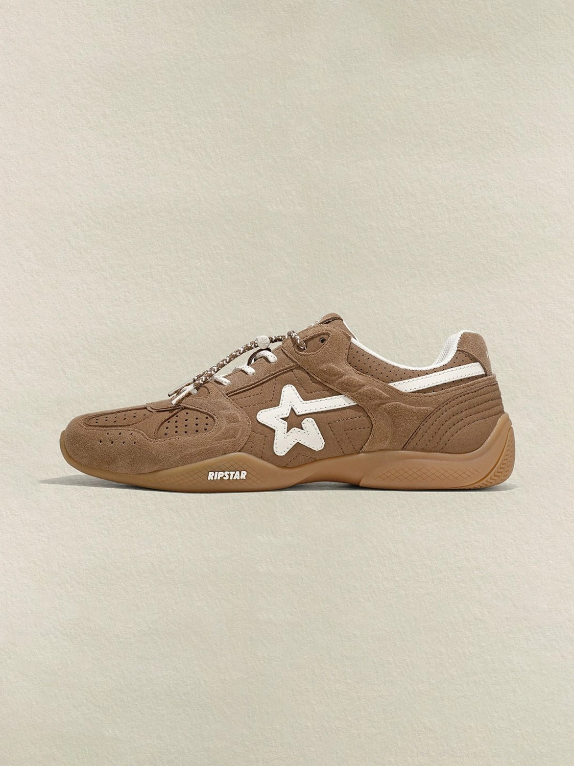 Side studio view of a mocha brown suede retro sneaker with cream star accent and streamlined gum rubber sole