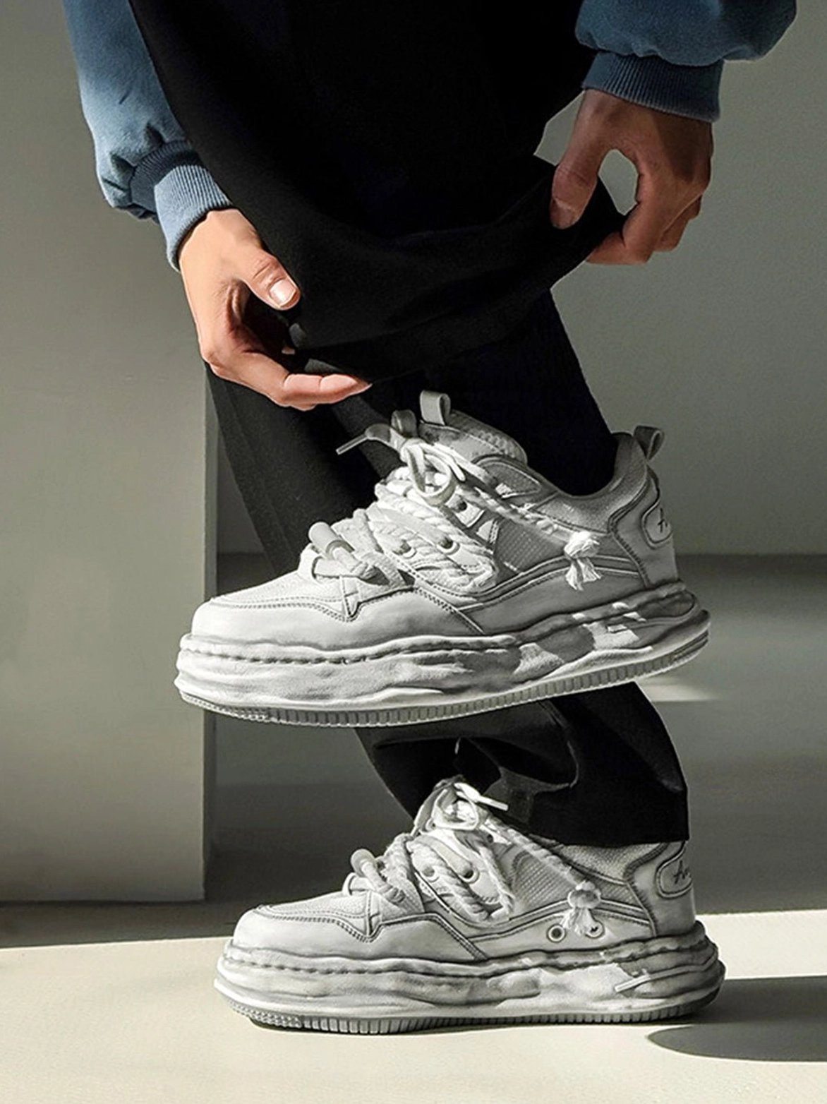 Modern distressed gray wavy platform sneakers with vintage-inspired styling for denim, trousers, and oversized outfits