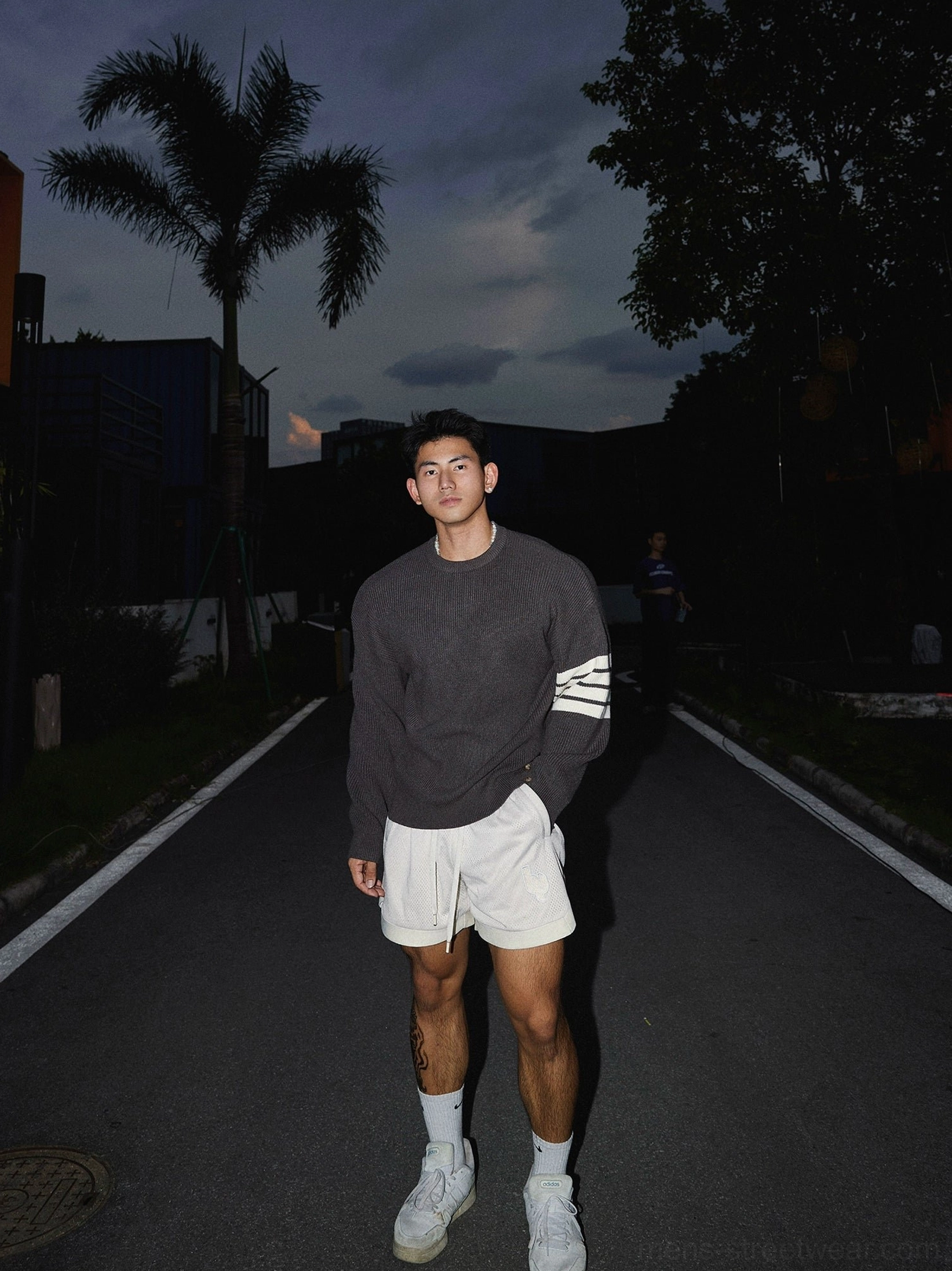 Modern Korean style striped sleeve knit sweater featuring a classic crewneck, relaxed drop shoulders, and graphic triple stripe accents