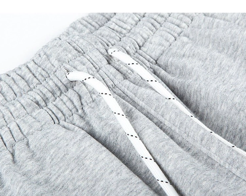 Modern oversized streetwear shorts featuring elastic waistband side pockets and understated neutral color styling