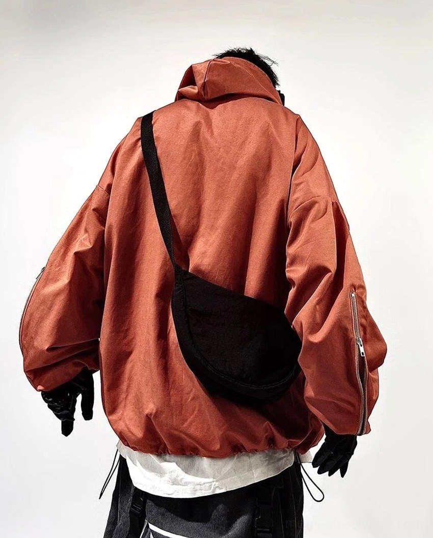 Modern oversized techwear jacket designed for layered outfits with hood, utility pockets, and relaxed streetwear fit