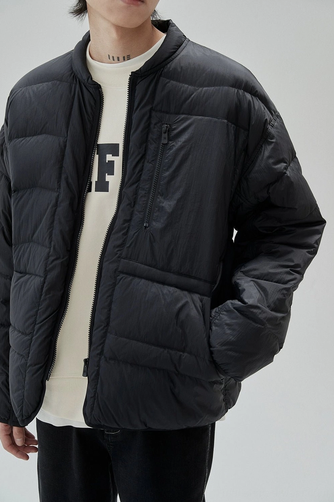 Modern varsity-inspired sweatshirt with arched UNIFORM lettering and relaxed urban silhouette