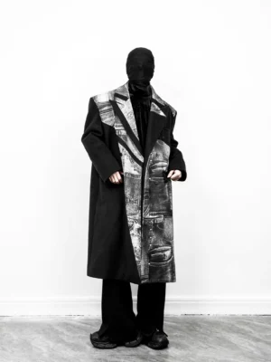 Black oversized long overcoat with monochrome denim print panels three-quarter front view
