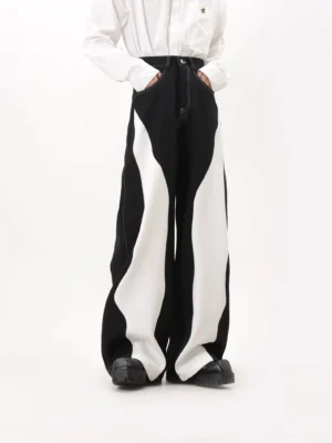 Three-quarter front view of black and white contrast wave patchwork wide-leg trousers with high waist and visible button fly