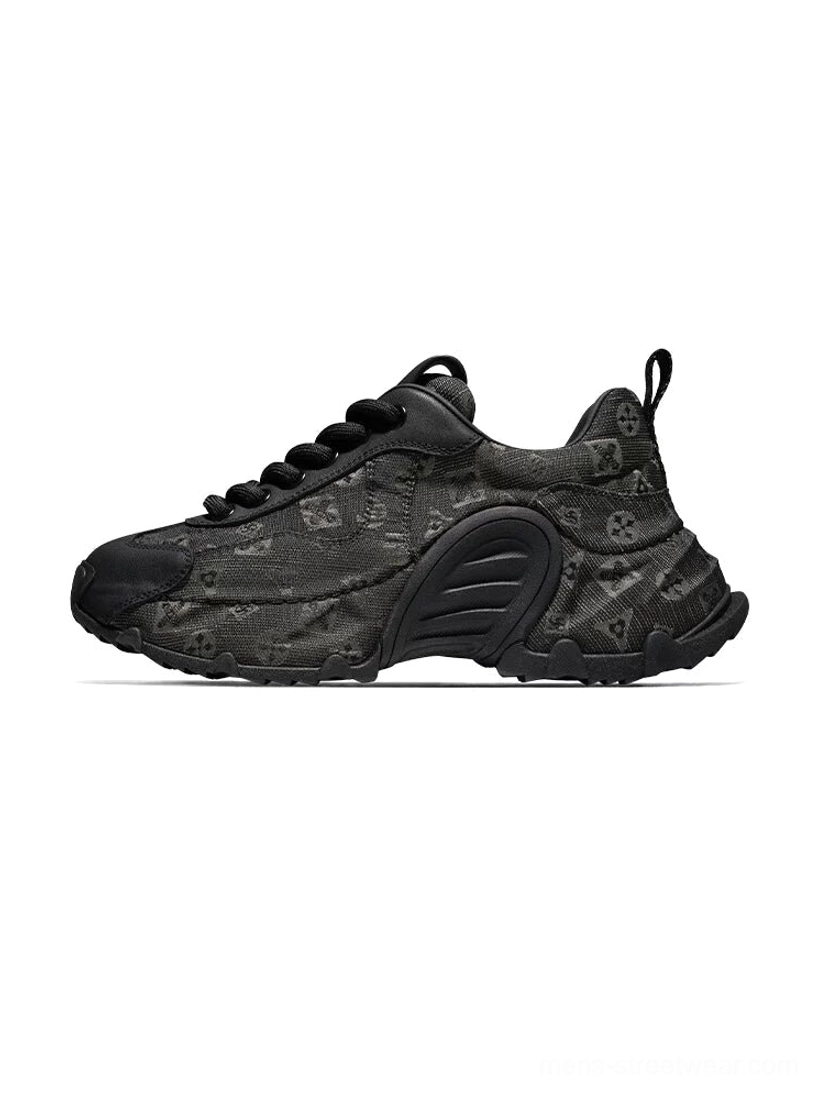 Dark monogram drift chunky sneakers in left side profile with black toe cap and sculpted black rubber sole