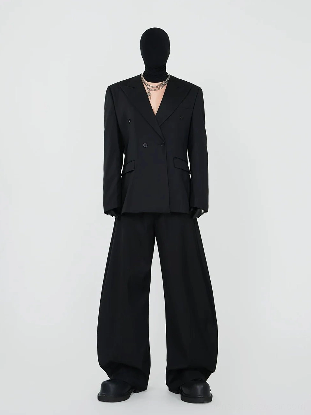 Black double-breasted blazer and wide-leg trousers in an avant-garde Korean streetwear tailored outfit front view