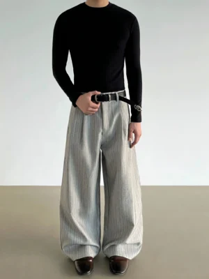 Front view of gray pinstripe wide-leg pleated trousers showing the high-waisted tailored silhouette and relaxed draping legs