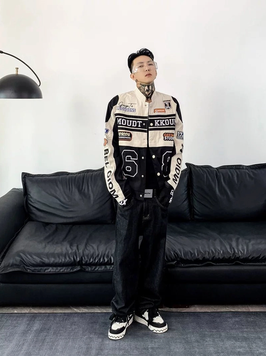 Motorcycle racing varsity jacket product detail showing color-block panels, racing patches, graphic numbers, and streetwear construction