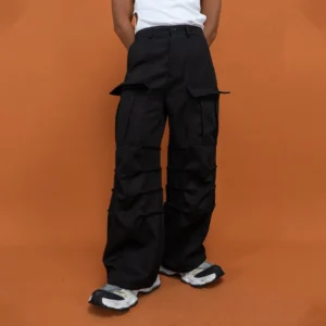 Black multi-pocket crinkled cargo pants with layered flap pockets and oversized wide-leg streetwear silhouette