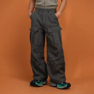 Green multi-pocket crinkled cargo pants shown from the front with a wide-leg Korean streetwear fit and chunky sneakers