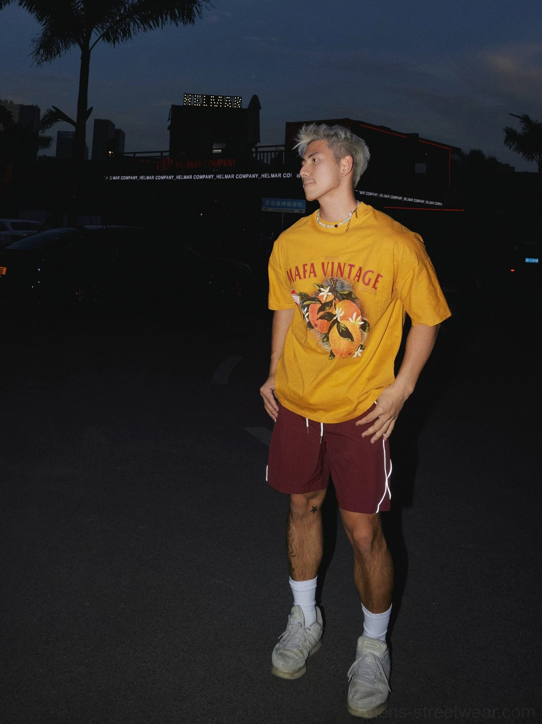 Side view of mustard yellow oversized citrus fruit graphic T-shirt with relaxed drop shoulder fit and casual streetwear styling