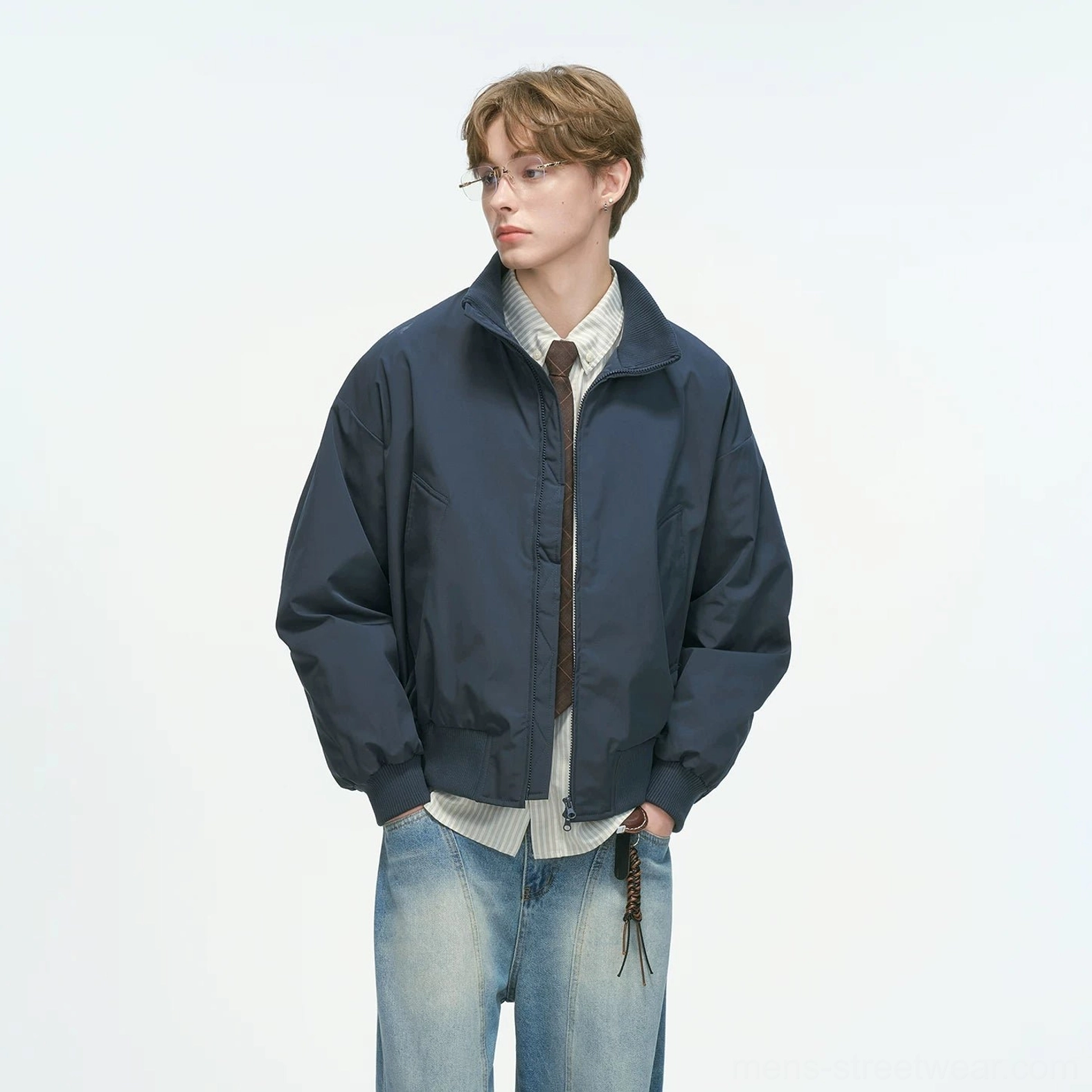 Navy blue bomber jacket standalone display shot showing complete garment structure, stand collar, ribbed trims and clean neutral colorway streetwear