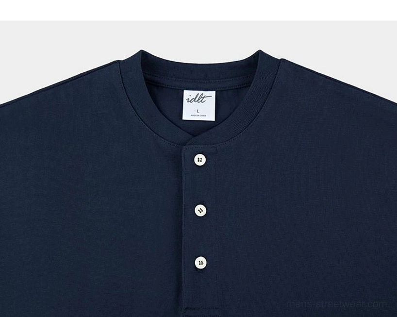 Navy blue cotton Henley T-shirt upper chest close-up with relaxed neckline and clean three-button design